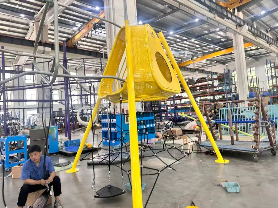 HonPlay factory assembly area with yellow custom play structure