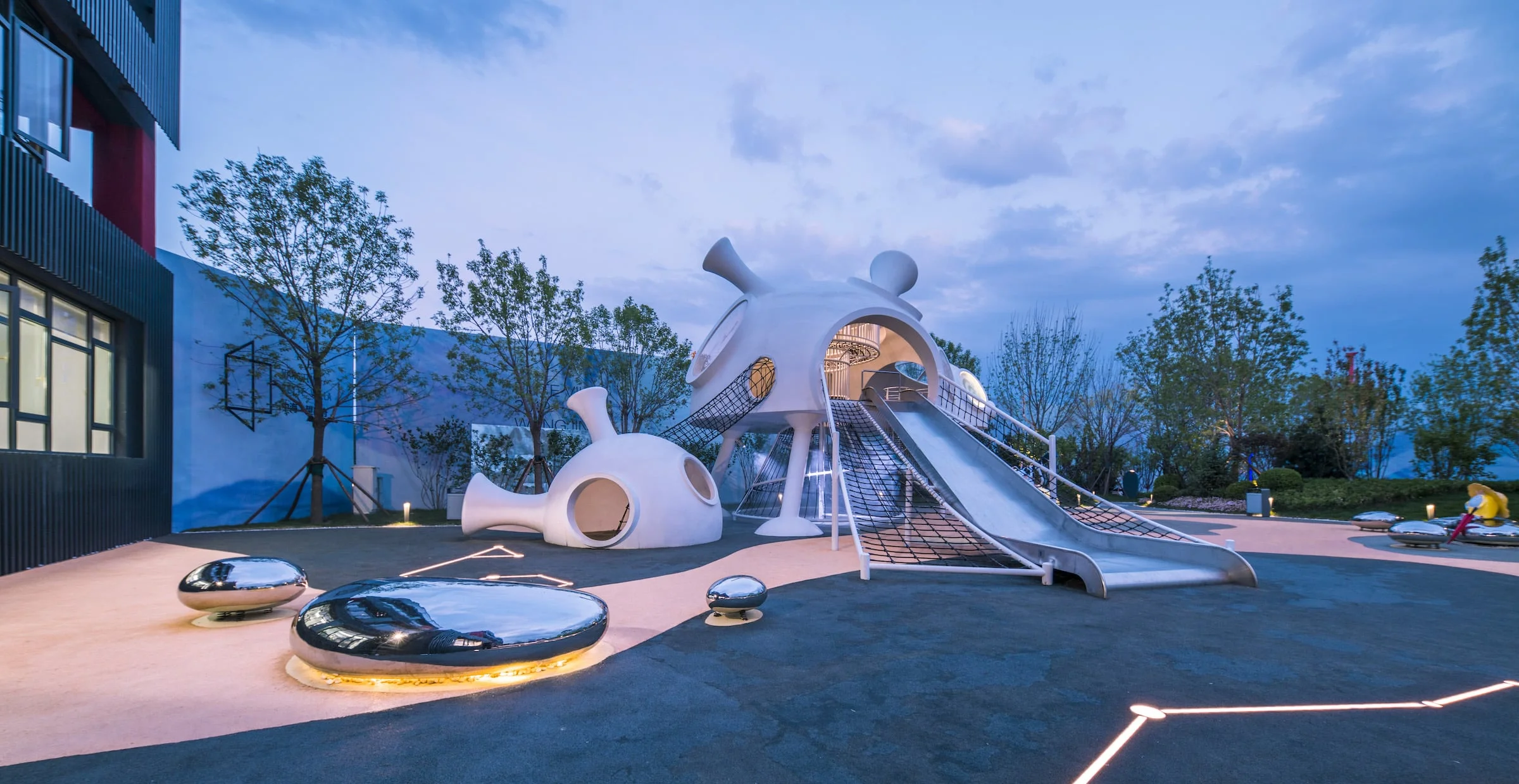 Futuristic Organic-Shaped Playground Structure in Galvanized Steel & HDPE with white pods and reflective pebble seats for Shanghai.