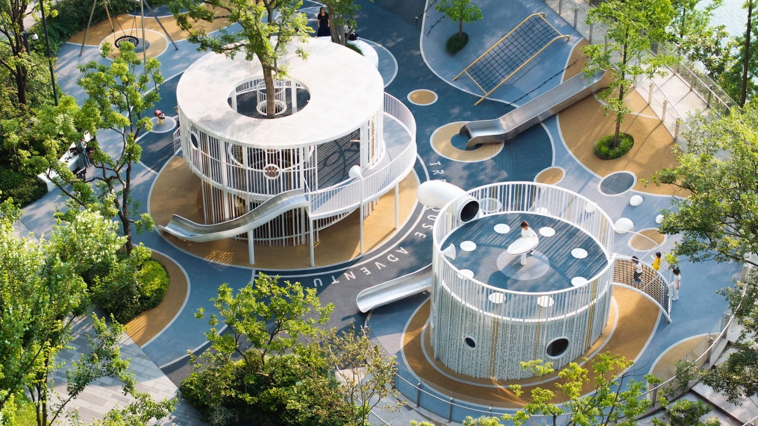 Circular Treehouse Adventure Playground in Galvanized Steel & HDPE with integrated trees and slides for Singapore urban parks.