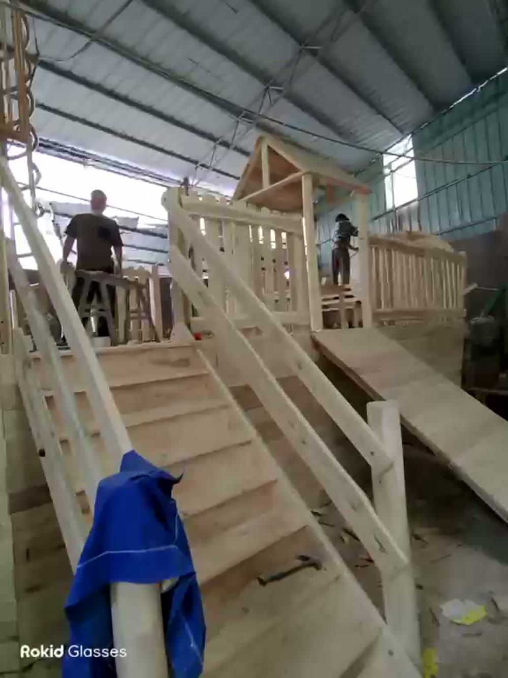 Hon Playground craftsmen assembling the wooden deck, stairs and boarding ramp of the customized pirate ship playground by hand.